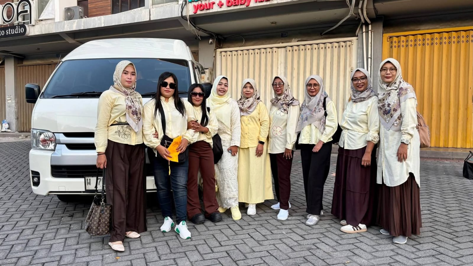 Toyota Hiace putih R&R Rent Car bersama rombongan penumpang